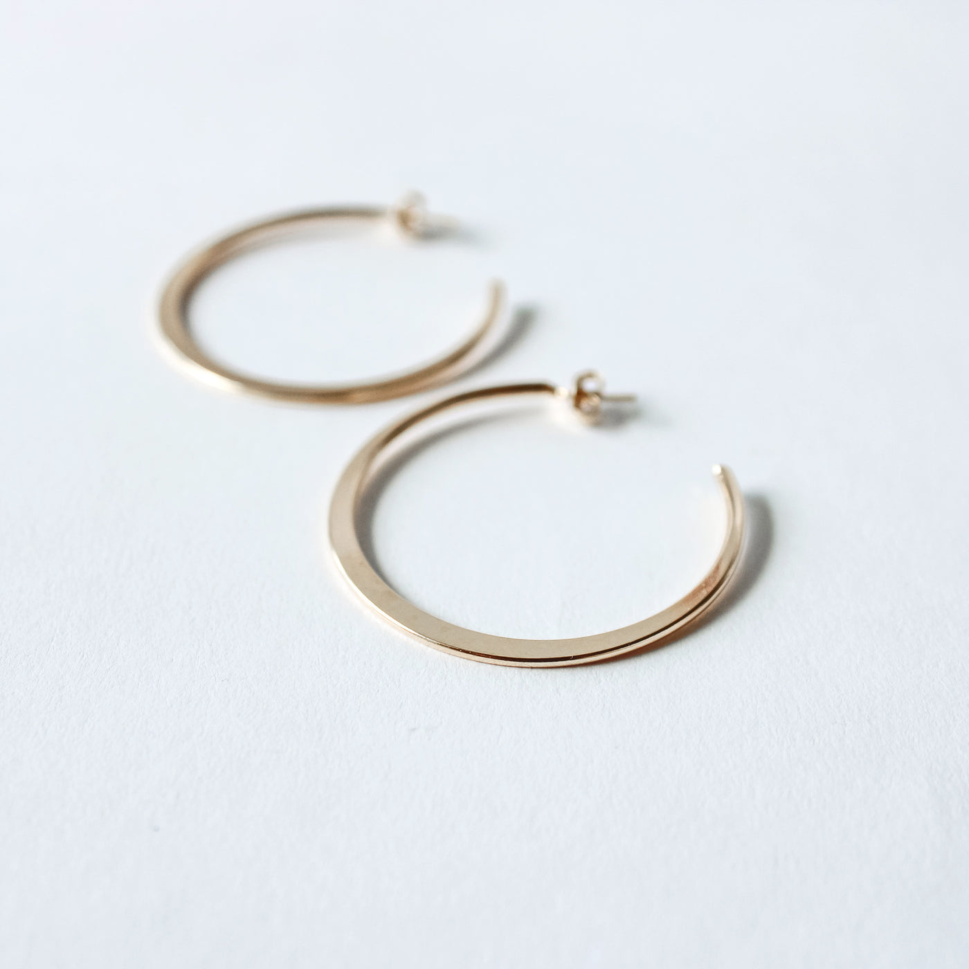 flattened gold hoop earrings