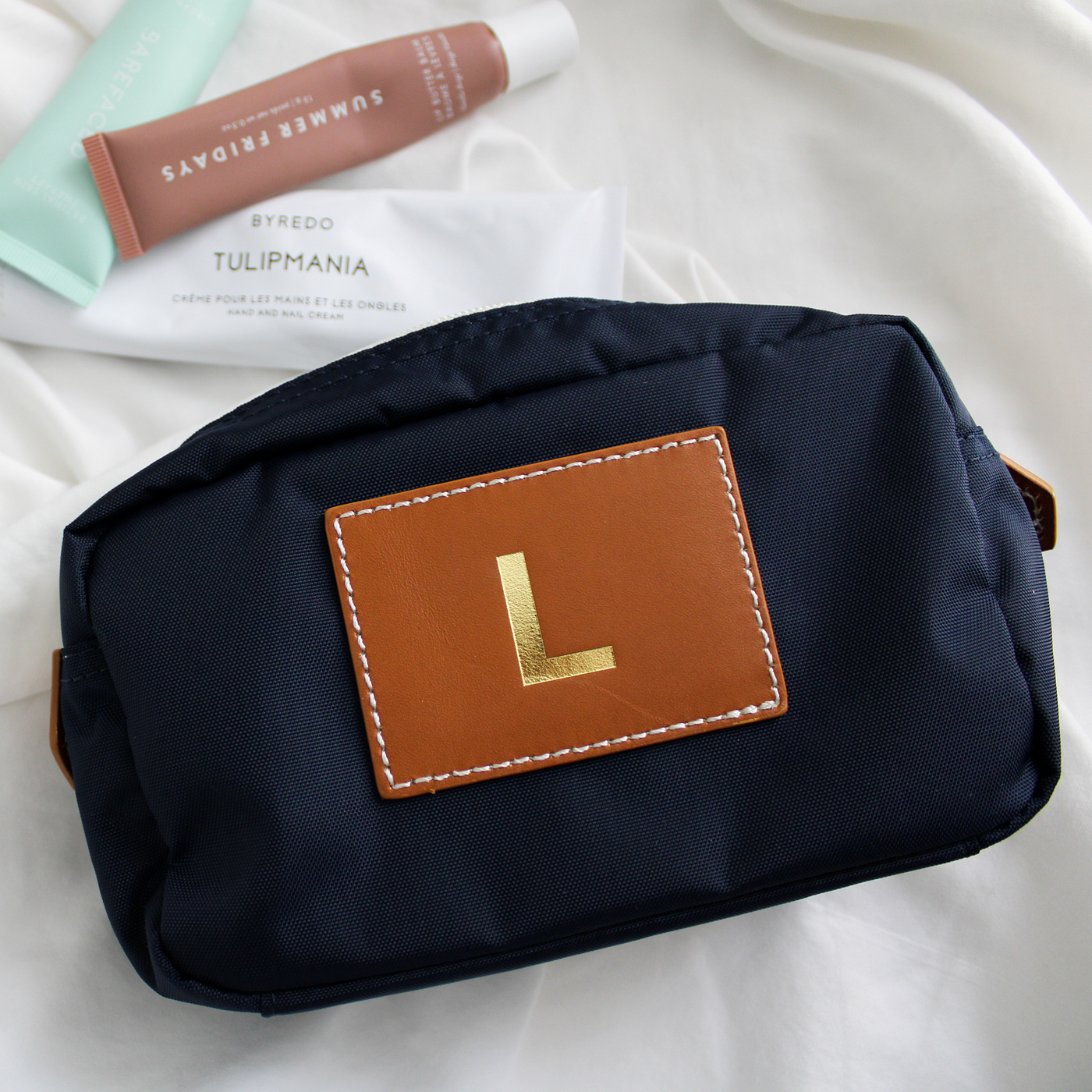 nylon navy cosmetic pouch with gold initial